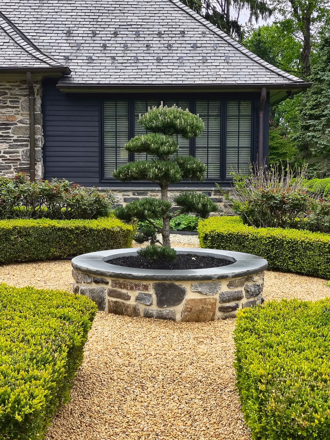 Stone planter and formal landscape